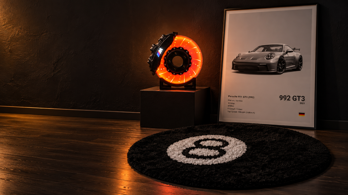 Styled arrangement of the M-inspired brake disc lamp, 8-ball rug and 992 GT3 print