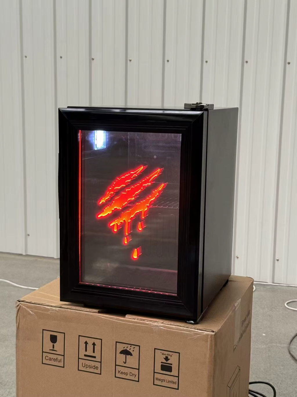 Original supplier photograph of the black mini fridge with red claw design.