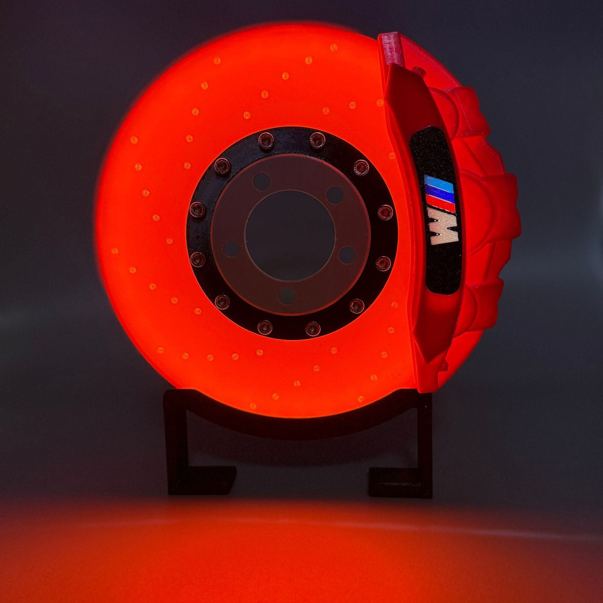Current M-Inspired Brake Disc Lamp — red caliper, supplier photograph